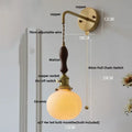 Vintage brass wall light with ribbed glass and knob switch bedroom