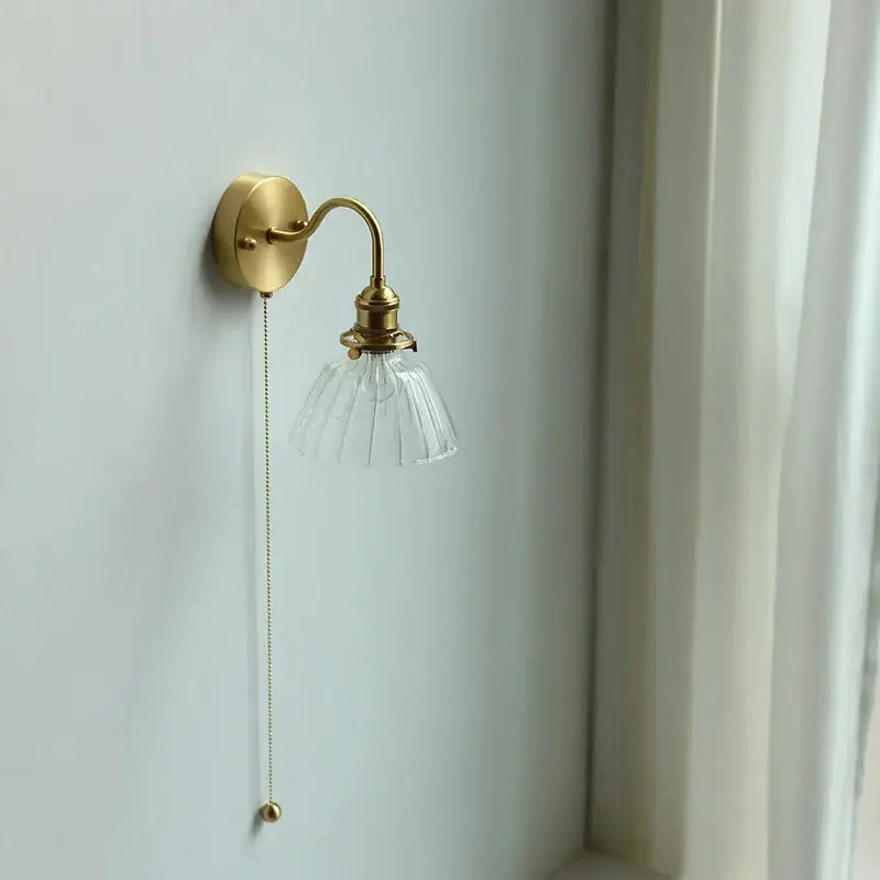 Vintage brass wall sconce with scalloped clear glass for stairways