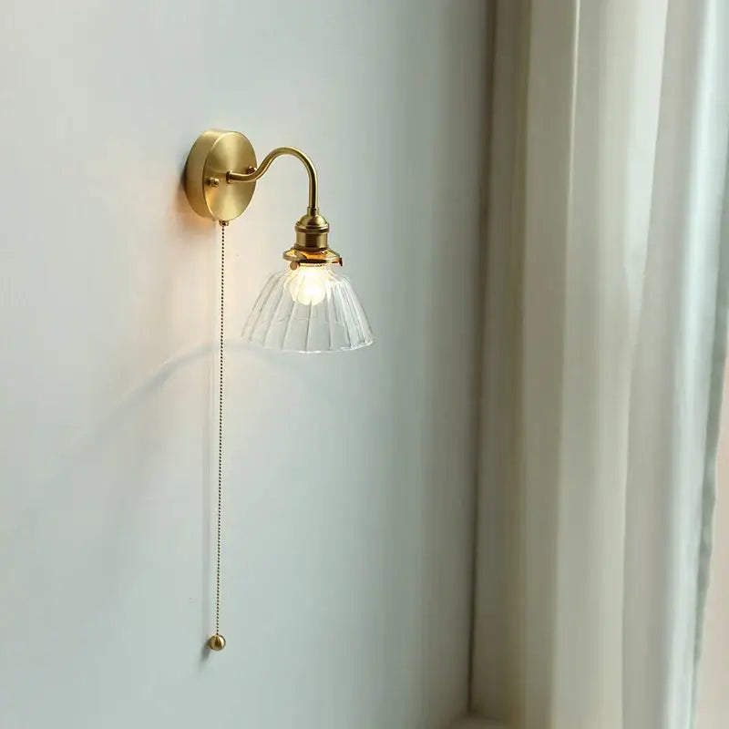 Vintage brass wall sconce with scalloped clear glass for stairways