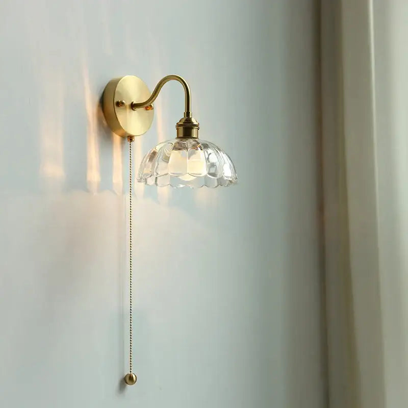 Vintage brass wall sconce with scalloped clear glass for stairways