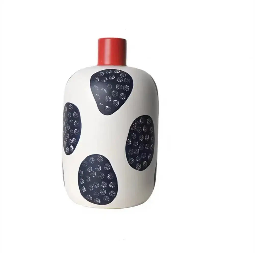 White ceramic polka dot vase with colorful graffiti lines living room