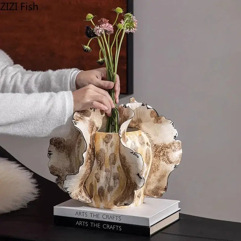 White & gray ruffled ceramic vase with artificial flowers living room