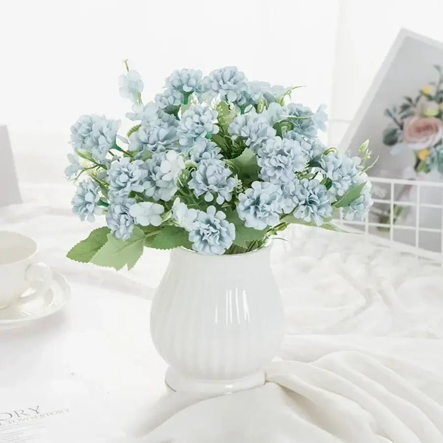 White hydrangea bouquet in ribbed glass vase for living room decor