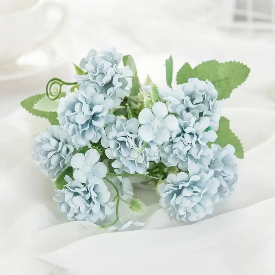 White hydrangea bouquet in ribbed glass vase for living room decor