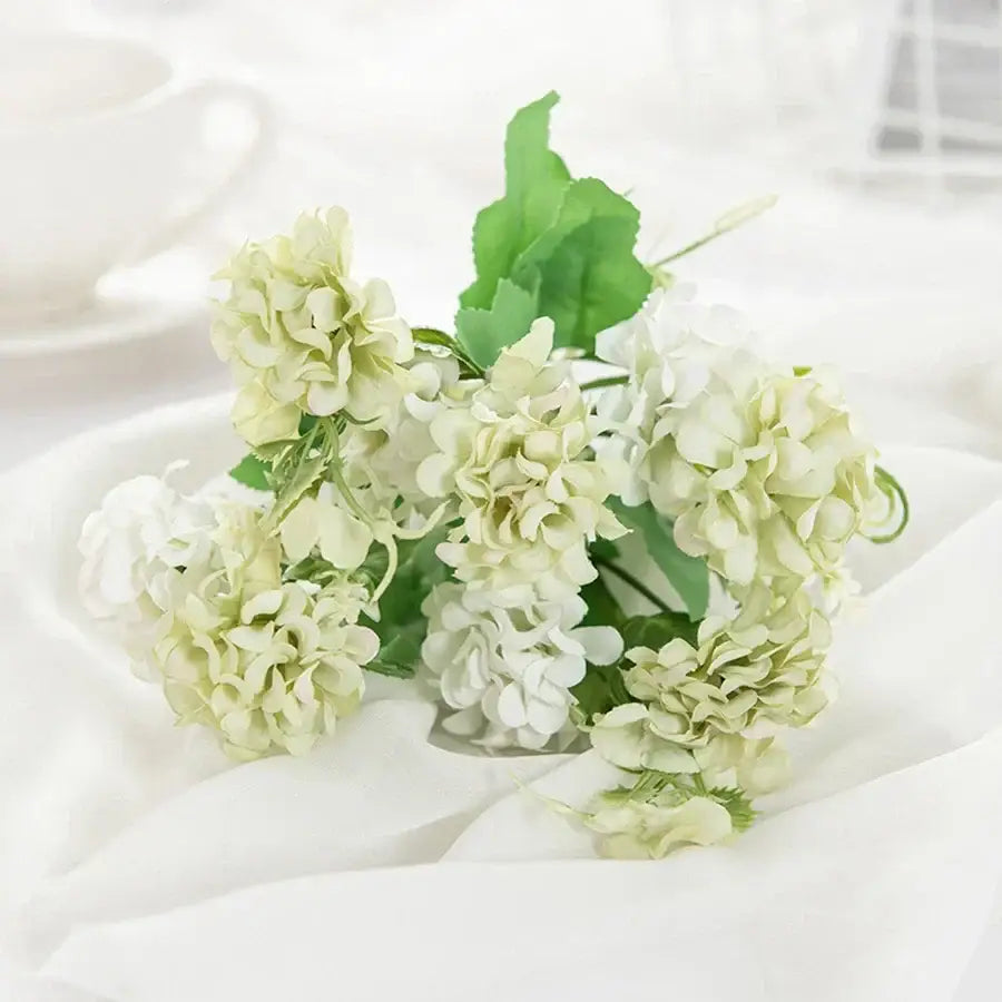 White hydrangea bouquet in ribbed glass vase for living room decor
