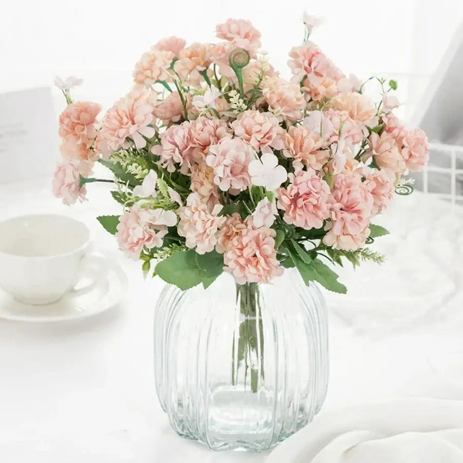 White hydrangea bouquet in ribbed glass vase for living room decor