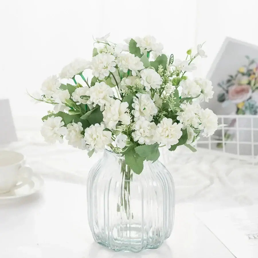 White hydrangea bouquet in ribbed glass vase for living room decor