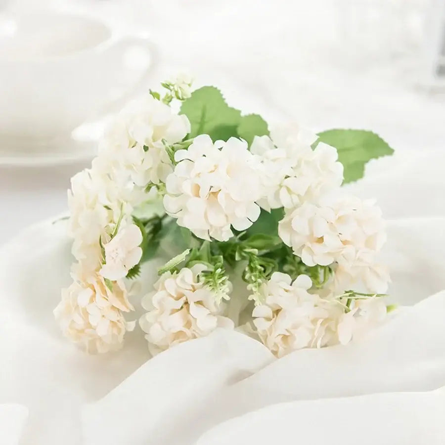 White hydrangea bouquet in ribbed glass vase for living room decor