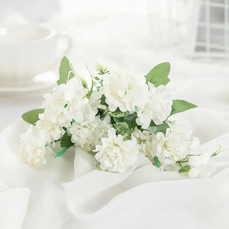 White hydrangea bouquet in ribbed glass vase for living room decor