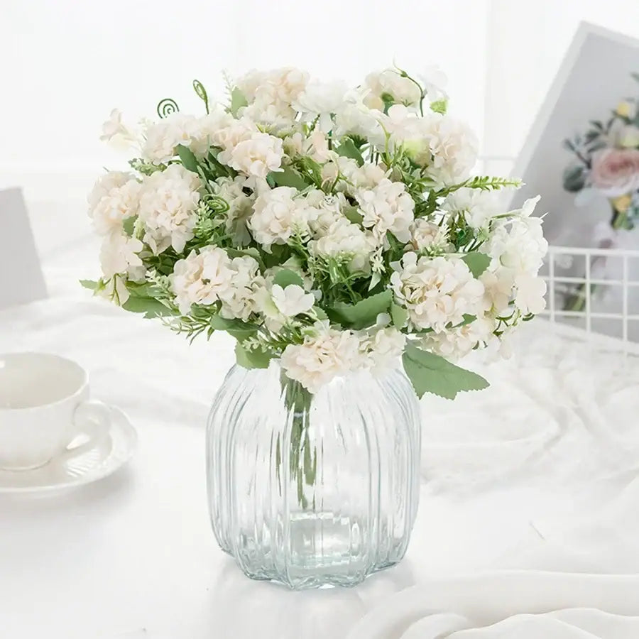 White hydrangea bouquet in ribbed glass vase for living room decor
