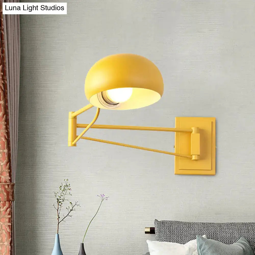 Yellow adjustable metal wall sconce with bowl shade for bedroom